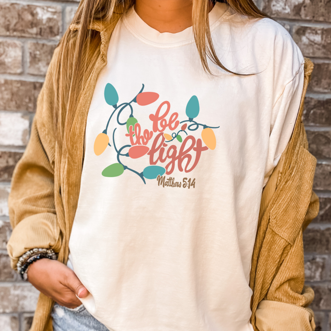 Be The Light Christmas Tee- Christmas Graphic Tshirt: Ivory / Large